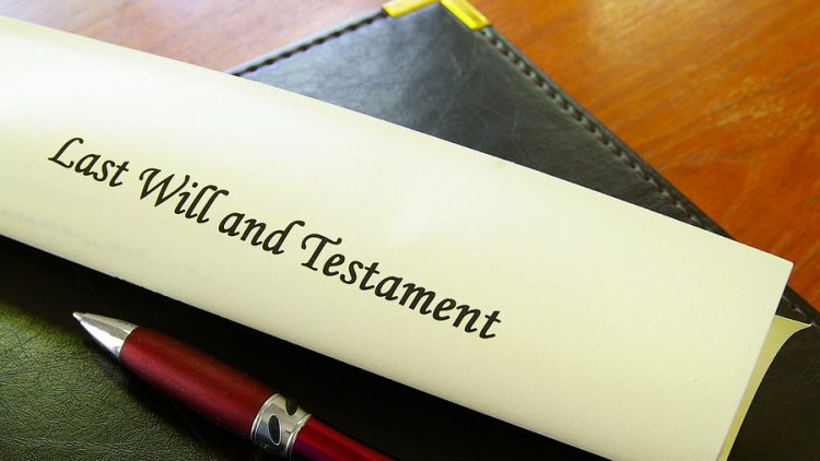 a last will and testament on a desk with a red pen. this image is being used to convey estate planning and the importance of understanding the difference between a will and a trust and why you need to work with ogborne law, phoenix estate planning attorney
