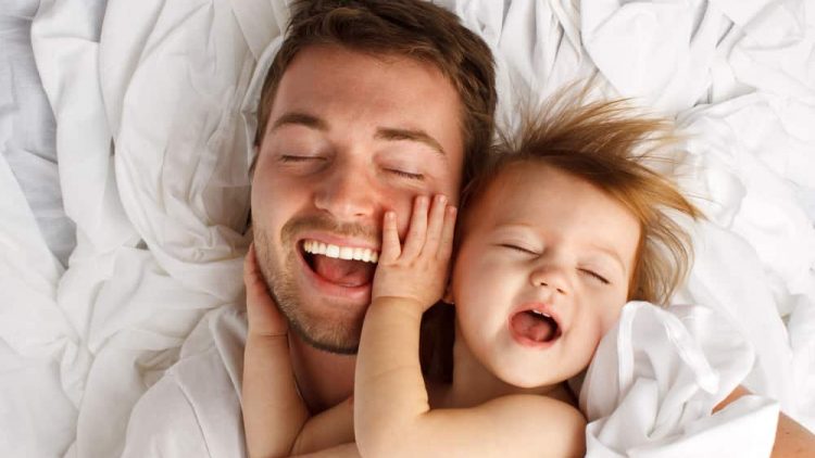 Father and daughter laughing and bonding to represent good parenting