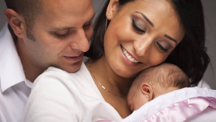 Happy Young Attractive Family with Newborn Baby